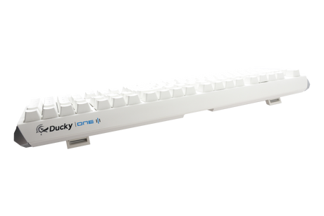 A Ducky One 3 - Classic Pure White Nordic - Fullsize - Cherry Silent Red mechanical keyboard with white PBT keycaps on a white background, viewed from a side angle, highlighting the elevated keys and brand logo.