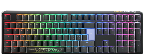 A colorful backlit mechanical gaming keyboard with vibrant rainbow LED lights, featuring a Ducky One 3 - Classic Black / White Nordic - Fullsize - Cherry Red logo on the space bar and a dark gray frame. The keys are laid out in a typical QWERTY configuration.