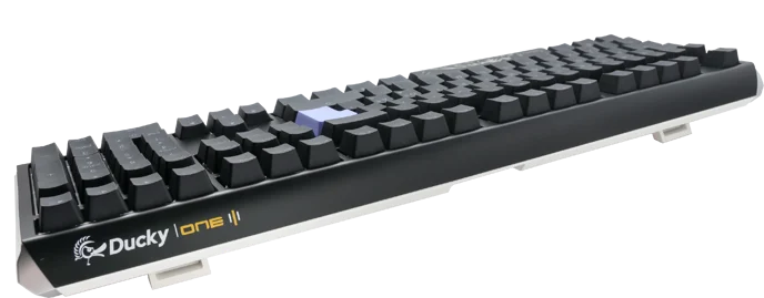 A Ducky One 3 - Classic Black / White Nordic - Fullsize - Cherry Silver mechanical keyboard with black keycaps and a white LED indicator on a gloss black case, viewed from a diagonal angle.