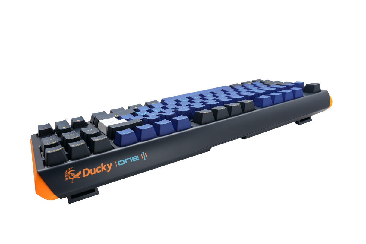 Side view of a Ducky One 3 - Horizon Nordic - TKL - Cherry Blue mechanical keyboard, featuring an orange accent on the space bar and vibrant blue PBT keycaps on a white background.