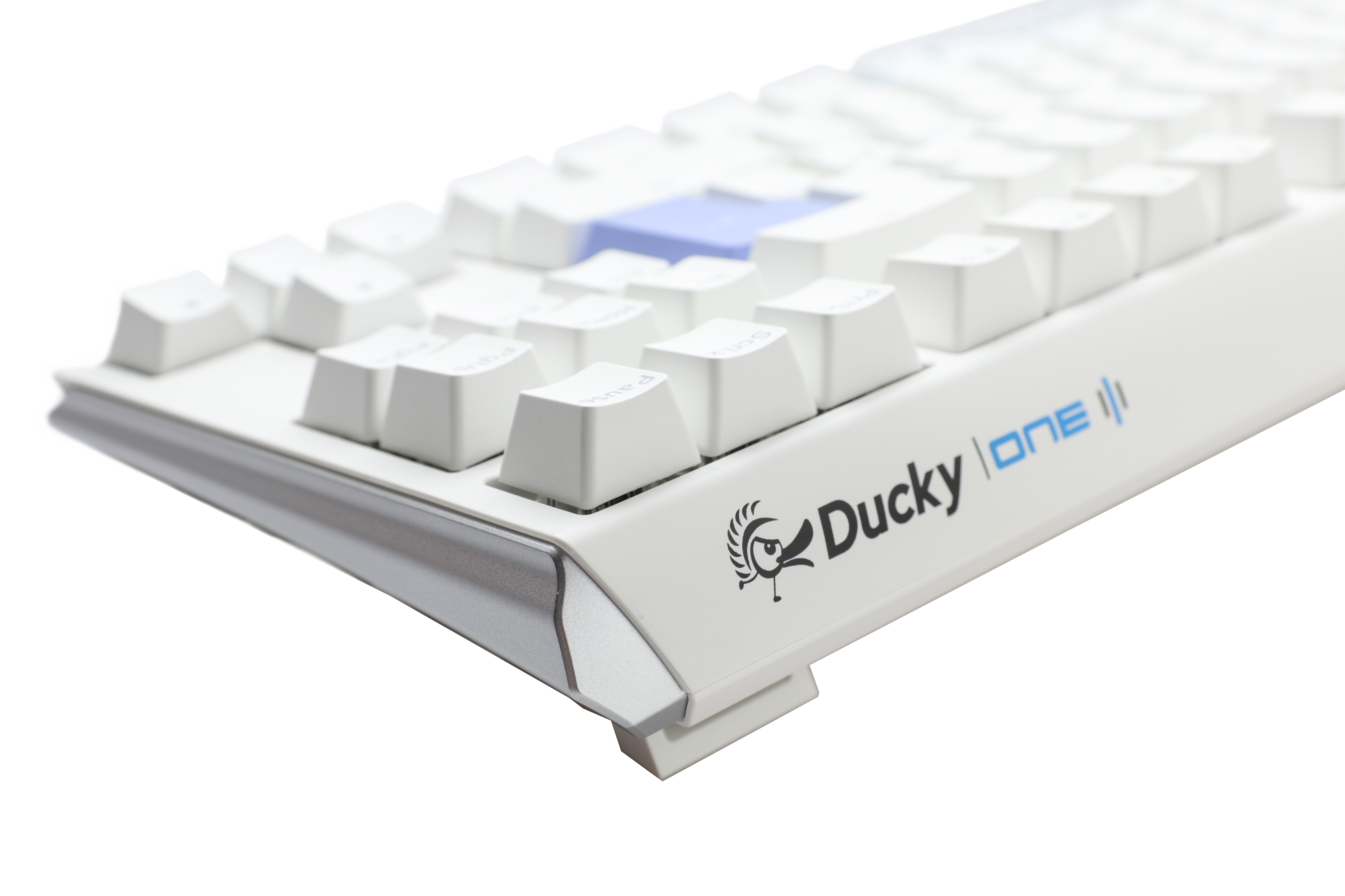 A close-up of a white mechanical keyboard, featuring PBT keycaps and the "Ducky" brand visible on the front side, set against a plain, light gray background.
